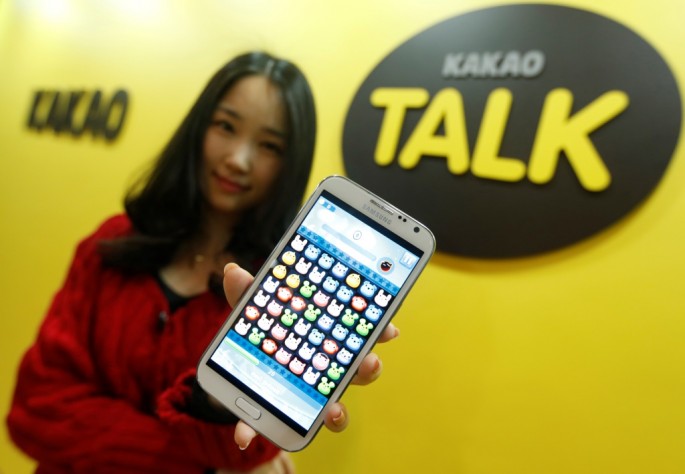 A Kakao Talk employee displays a mobile game on a smartphone at the company’s headquarters in Seongam, South Korea.