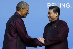 U.S. President Barack Obama (L) shakes hands with Chinese President Xi Jinping.