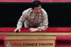 Actor Jackie Chan poses during a hand and footprint ceremony at the TCL Chinese Theatre.