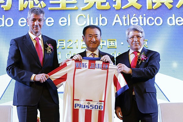 Wang Jianlin, owner of the Wanda Group, as he receives a jersey from Atletico Madrid officials.