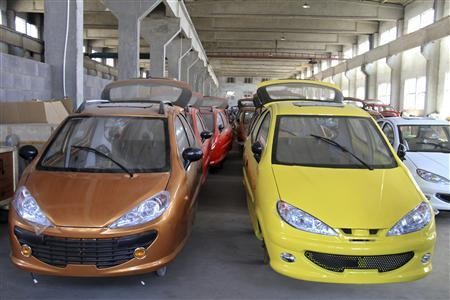 Bodies of electric cars are arranged inside a factory in Weihai, Shandong Province.