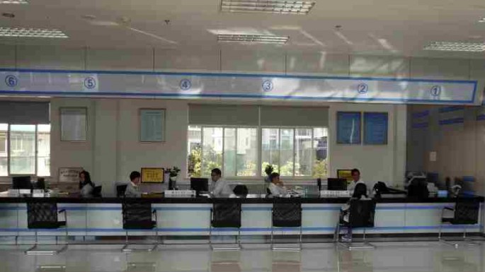 Clerks wait for customers inside Wenzhou Private Lending Service Center, in Wenzhou, Zhejiang Province, Oct. 25, 2013.
