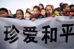 Children hold a banner saying 
