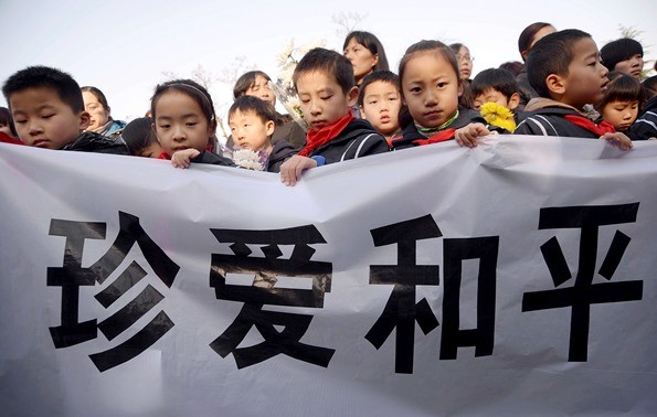 Children hold a banner saying "love peace."
