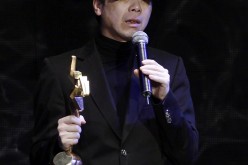Chinese director Feng Xiaogang receives the Best Top Grossing Film award for the movie 