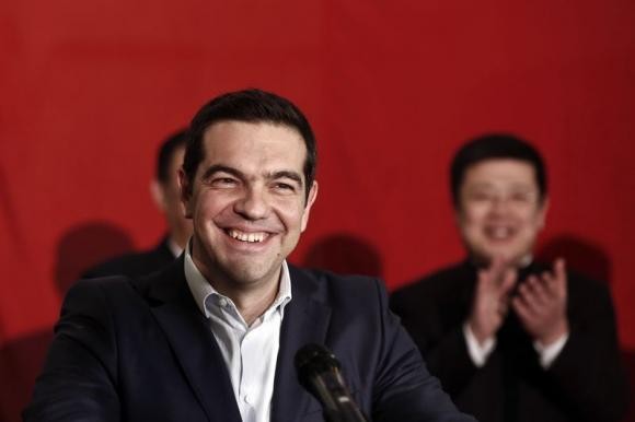 Greek Prime Minister Alexis Tsipras smiles during his speech aboard the Chinese frigate Changbaishan. 