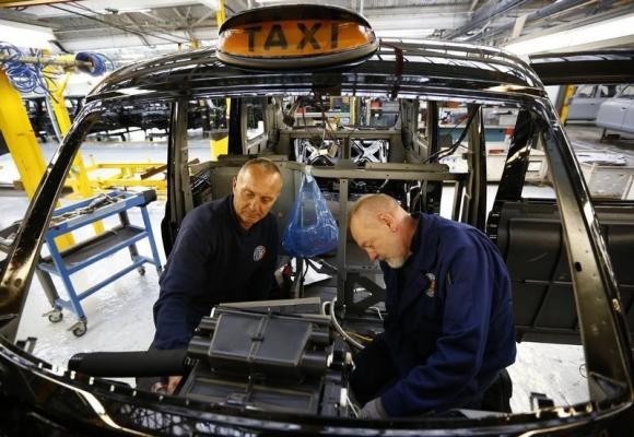 Men work on the production line at the London Taxi Company in Coventry, Central England.
