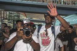 NBA player Dwyane Wade (front R) waves to fans in China.