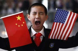 A boy yawns while awaiting Hilary Clinton's arrival in Beijing.