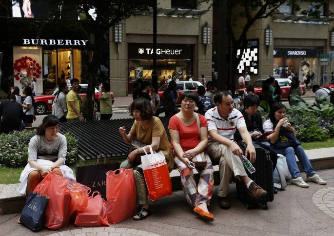 Shoppers rest outside a shopping mall on Russell Street at Hong Kong's Causeway Bay shopping district, June 17, 2014. 