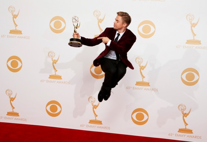 Derek Hough from ABC's "Dancing With the Stars" jumps backstage with his award for Outstanding Choreography at the 65th Primetime Emmy Awards in Los Angeles September 22, 2013.