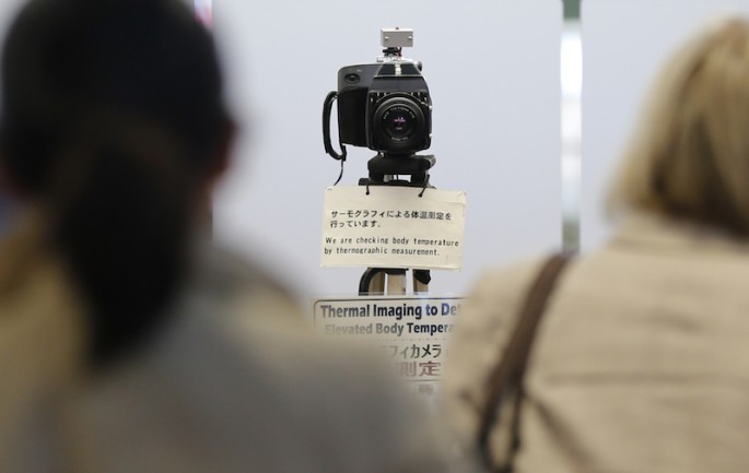 A camera for a thermographic imaging device checks the temperatures of arriving passengers from China at the quarantine station at Haneda International Airport in Tokyo, April 5, 2013.