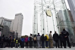 Customers line up in front of a new Apple Store in Chongqing, Jan. 31, 2015. Apple was one of the companies dropped from China's state procurement list amid cybersecurity concerns.