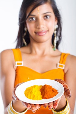 Indian Lady holding turmeric powder