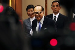 Li Ka-shing smiles as he leaves a news conference on the companies' annual results in Hong Kong on Feb. 26.