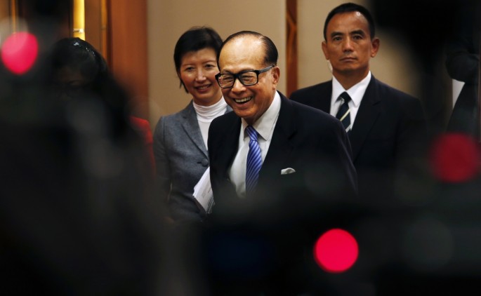 Li Ka-shing smiles as he leaves a news conference on the companies' annual results in Hong Kong on Feb. 26.