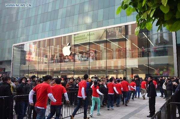 Customers wait in front of the newly opened Apple Store in Shenyang, China.