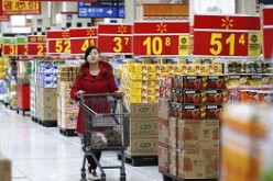 A shopper looks for imported food products at a Walmart shop in Beijing. 