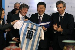 President Xi Jinping receives a jersey with his name worn by Argentinean soccer superstar Lionel Messi, July 2014.