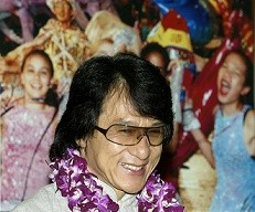 Hong Kong actor and director Jackie Chan smiles past a crowd of cheering fans.