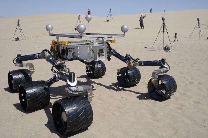 Members of the Mars Science Laboratory/Curiosity team, which includes rover drivers and scientists, test out an engineering model of its next generation Mars rover, dubbed "Curiosity", in the desert near Baker, California May 10, 2012. According to a pres