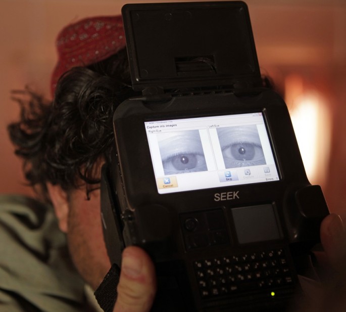 A U.S Army soldier of the 2nd Battalion 1st Infantry Regiment takes a biometric scan of an Afghan local police.