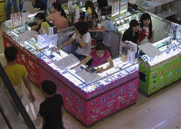 Smartphones and tablets are being sold in booths at a mall in Shenzhen.