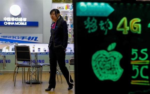 A sales assistant walks inside a China Mobile store in China.