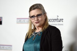 Honoree Carrie Fisher poses at the Oscar Wilde Awards at director J.J. Abrams' Bad Robot production company in Santa Monica, California February 19, 2015.