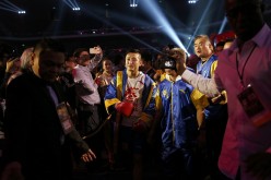 Zou Shiming of China walks to the ring before his International Boxing Federation (IBF) world flyweight title fight against Thai Amnat Ruenroeng at the Venetian Macao hotel in Macau, March 7, 2015.