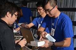 An Apple worker  inspects a package in Hong Kong. 