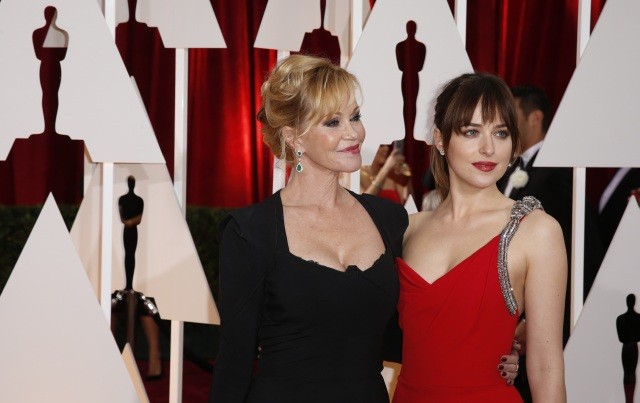 "50 Shades of Grey" actress Dakota Johnson arrives with her mother Melanie Griffith (L) at the 87th Academy Awards