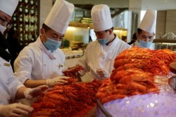 Chinese chefs prepare Boston lobsters at a hotel restaurant in Beijing.