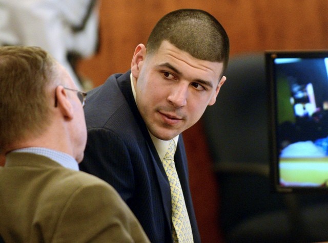 Former New England Patriots football player Aaron Hernandez (R) confers with his attorney Charles Rankin during his murder trial in Fall River, Massachusetts March 13, 2015.