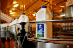 Bottles of milk are seen on the production line at a Dairy Farmers processing facility.