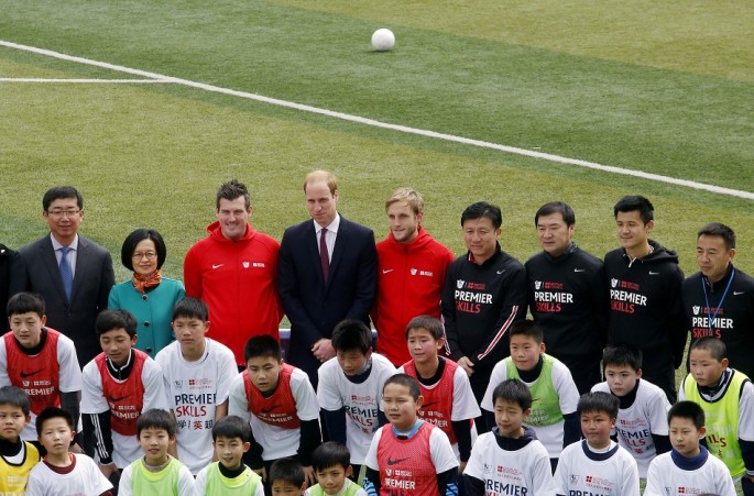 Britain's Prince William (rear C) poses for a group picture during a visit to a Premier League training camp at Nanyang Secondary School in Shanghai, March 3, 2015. 