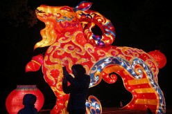 Visitors take pictures in front of a goat-shaped lantern ahead of the Lantern Festival in Wuhan, Hubei Province, Feb. 28, 2015.