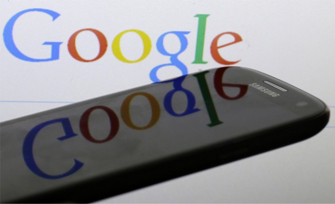 A Google logo is reflected on the screen of a Samsung Galaxy S4 smartphone in this photo illustration taken in Prague January 31, 2014. Google Inc and Samsung Electronics Co Ltd, which are frequently involved in patent infringement lawsuits but not agains