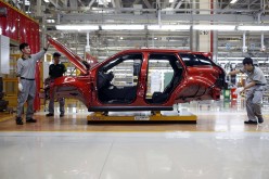 Employees work at the production line inside the Chery Jaguar Land Rover plant before the plant's opening ceremony in Changshu, Jiangsu Province.