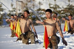 People's Liberation Army (PLA) soldiers practice with swords during a winter training in Heihe, Heilongjiang Province.