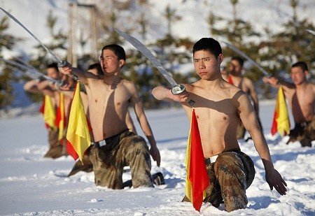 People's Liberation Army (PLA) soldiers practice with swords during a winter training in Heihe, Heilongjiang Province.