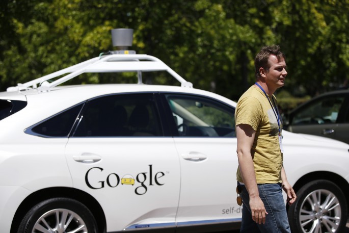 Chris Urmson, director of Google's Self-Driving Car Project, stands in front of a self-driving car