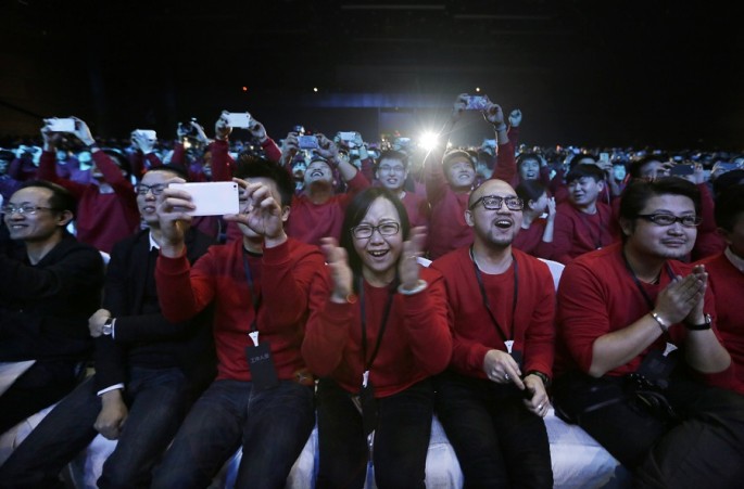 Xiaomi staff and users of Xiaomi phones react at the launch ceremony of the Mi Note in Beijing, Jan. 15, 2015.