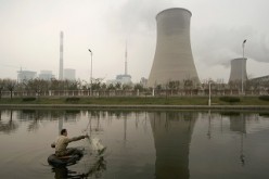 A man fishes near a thermal power plant in Tianjin.