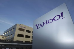 A Yahoo logo is pictured in front of a building in Switzerland. The Internet search giant ended its operations in China following budget cuts and pressure from investors.