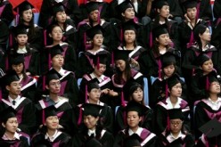 Graduating students of Tsinghua University listen during a commencement exercise.
