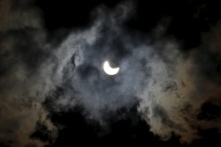 A partial eclipse of the sun is seen through clouds in Sarajevo March 20, 2015.