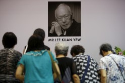 People bow as they pay their respects to the late former Prime Minister Lee Kuan Yew in Singapore.