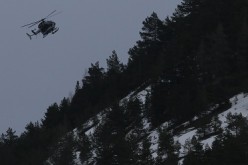 A rescue helicopter from the French Gendarmerie flies over the French Alps during a rescue operation near to the crash site of an Airbus A320, near Seyne-les-Alpes, March 24, 2015. An Airbus plane operated by Lufthansa's Germanwings budget airline, en rou