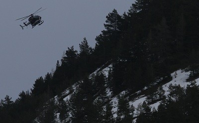 A rescue helicopter from the French Gendarmerie flies over the French Alps during a rescue operation near to the crash site of an Airbus A320, near Seyne-les-Alpes, March 24, 2015. An Airbus plane operated by Lufthansa's Germanwings budget airline, en rou